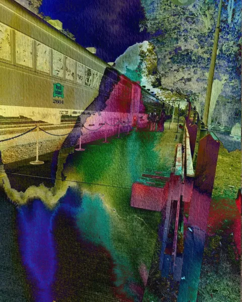 A vintage railroad car breaking into bands of red, green and violet