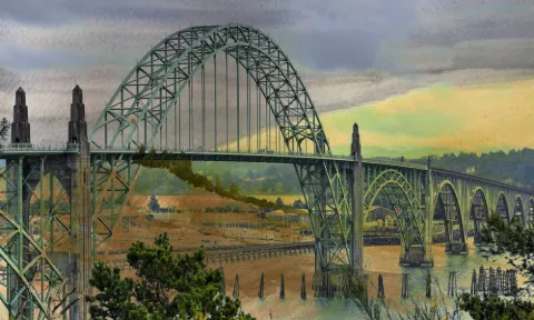 The arched Waldport bridge over the bay under an amber sky